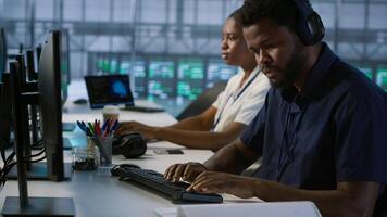 Engineer in server room looking over documents, developing disaster recovery plans ensuring minimal downtime. Worker reading paperwork in data center, using analytics to monitor performance, camera A photo