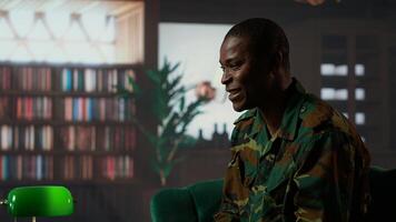 Black distraught war veteran crying due to shell shock and combat flashbacks, cure his anxiety after traumatic experiences. Army soldier dealing with a mental disorder during therapy. Camera B. photo
