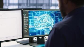 Machine learning expert in AI server room developing disaster recovery plans ensuring minimal downtime. Employee monitoring performance in artificial intelligence ran data center, camera A photo