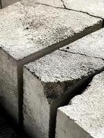 Closeup view of cracked concrete blocks showing texture photo
