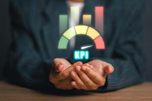 Hands holding a KPI icon with colorful bar graphs, symbolizing key performance indicators in business analytics and performance measurement. photo