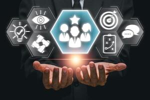 Hands presenting leadership icons symbolizing teamwork, vision, and strategy in a modern business context. photo