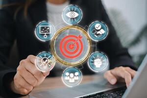 Businesswoman analyzing goals and strategy with target icon, representing success and achievement in a modern business environment. photo