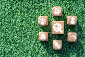 Wooden blocks with service icons on grass, symbolizing customer support, satisfaction, and innovative service concepts. photo