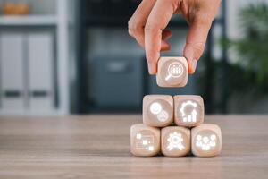Wooden blocks with icons symbolizing quality control, efficiency, and performance in business settings. photo