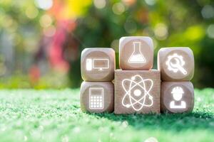 Creative representation of STEM education with icons for science, technology, engineering, and math on wooden blocks. photo
