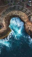 Devil tears with crashing waves in Lembongan island, Bali. Top down drone view video