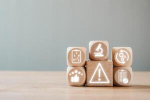 Conceptual Image Representing Risk with Wooden Blocks and Warning Symbols for Business and Financial Themes photo