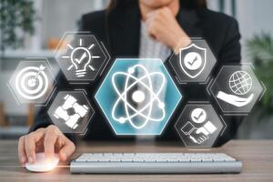 Businesswoman interacting with digital icons symbolizing core values like innovation, teamwork, and responsibility. photo