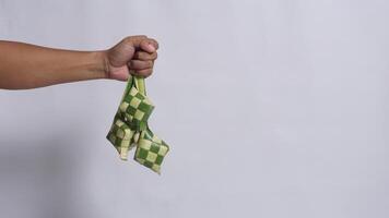 Hand Holds Ketupat Packaging with Copy Space photo