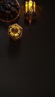 Ramadan Lantern With Glowing Candle and A Plate of Dates Fruit or Kurma photo