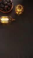 Lighted Gold Islamic Lanterns and A Plate of Dates Fruit or Kurma photo