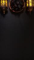 A Plate of Dates Fruit or Kurma Between Two Lighted Vintage Islamic Lanterns photo