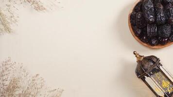 A Plate of Dates and A Lantern With Dry Plants Decoration photo