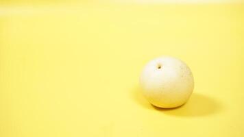 Asian or Nashi or Century Pear Isolated on Yellow Background photo