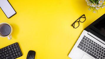 Top View of Copy Space with Working Stuffs on Yellow Background photo