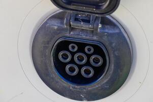 Exploring the intricate design of an electric vehicle charging port in a modern setting photo
