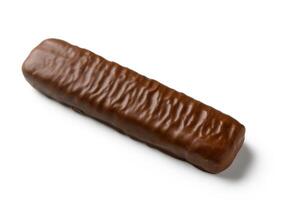 Decadent chocolate bar resting on a clean white surface, inviting indulgence with its smooth texture photo