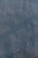 Layers of texture revealed in the interplay of shadow and light on an urban surface at sunrise photo