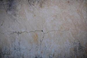 Cracked plaster wall revealing the passage of time in a rustic setting photo