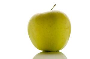 Fresh green apple sits elegantly on a reflective surface, showcasing its vibrant color and smooth texture photo