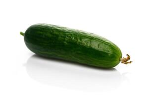 Fresh green cucumber resting on a clean surface ready for culinary creations and healthy snacks photo