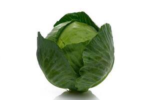 Fresh green cabbage resting on a clean surface in bright lighting photo