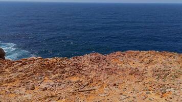 Top down view seashore cliffs wave crashing on rocks. Sardinia, Italy. video