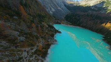 FPV drone flying close to the sharp mountain cliffs and Lago di Sorapis. Italy. video