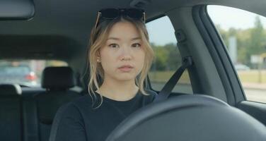 A woman in a car looking at the camera photo