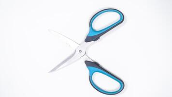Top View of Open Scissor with Blue and Black Handle Isolated on White Background photo
