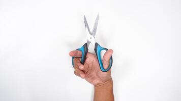 Hand Holding An Open Multipurpose Scissor Isolated on White Background photo