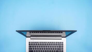 Top View of Laptop on Blue Background photo