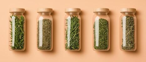 Natural herbs in glass jars on peach background, showcasing freshness and variety photo