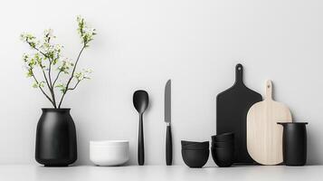 Minimalist kitchen scene with black and white utensils and flowers photo