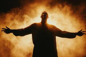 Powerful Silhouette of a Man Singing Against a Dramatic Orange Smoky Background photo