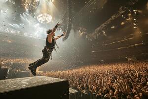 Epic Rock Concert Musician Soaring Above a Jubilant Crowd photo