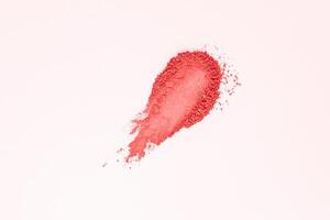 A beautiful sample texture of loose pink blush. Brushstroke on a white background. The texture of a cosmetic dry product. top view. A copy space. photo