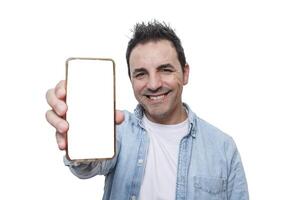 Smiling man holding a smartphone in front of a white background showcasing digital communication photo