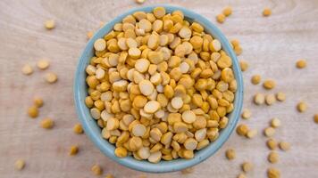 Flat Lay of Split Chickpeas Chana Dal Lentils in a Blue Bowl photo