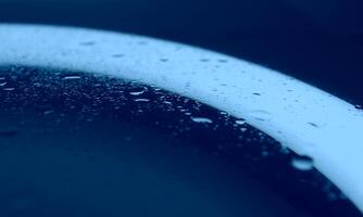 Sprinkled Water On Clean Glass In Blue Light Macro Shot Stock Photo