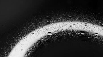 A pattern of finely splashed liquid on a transparent surface above a circle light source photo