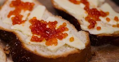 a soft loaf of wheat flour with butter and red salmon caviar photo