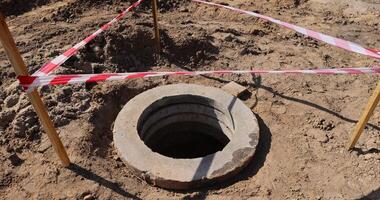 a deep hole in the ground on the site of which a highway was started photo