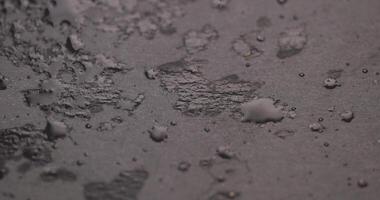 black slate surface for serving in drops of water photo