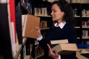 Woman Searching for Books in a Library Setting Surrounded by Bookshelves photo