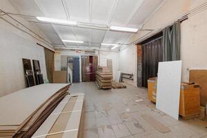 Under the Neon Glow An Industrial Workshop of Stacked Panels and Raw Materials Awaiting Creation. photo