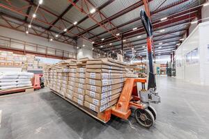Dynamic Warehouse Flow Stacks of Boxes on a Pallet Jack Illuminate the Heart of Industrial Efficiency. photo