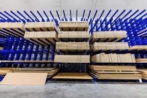 Bulk Bliss A Symphony of Blue Racks Supporting Sheets of Natures Canvas in an Expansive Warehouse. photo