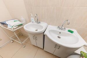 Serene Sanctuary A Contemporary Bathroom Haven with Gleaming Sinks and Stylish Functional Decor photo